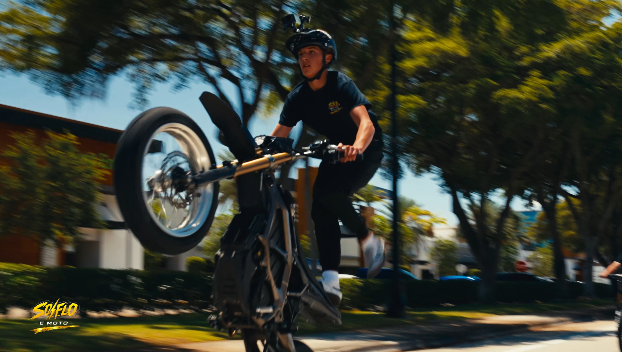 SoFlo E-Moto member rideout with a rider throwing a wheelie on a private crew run