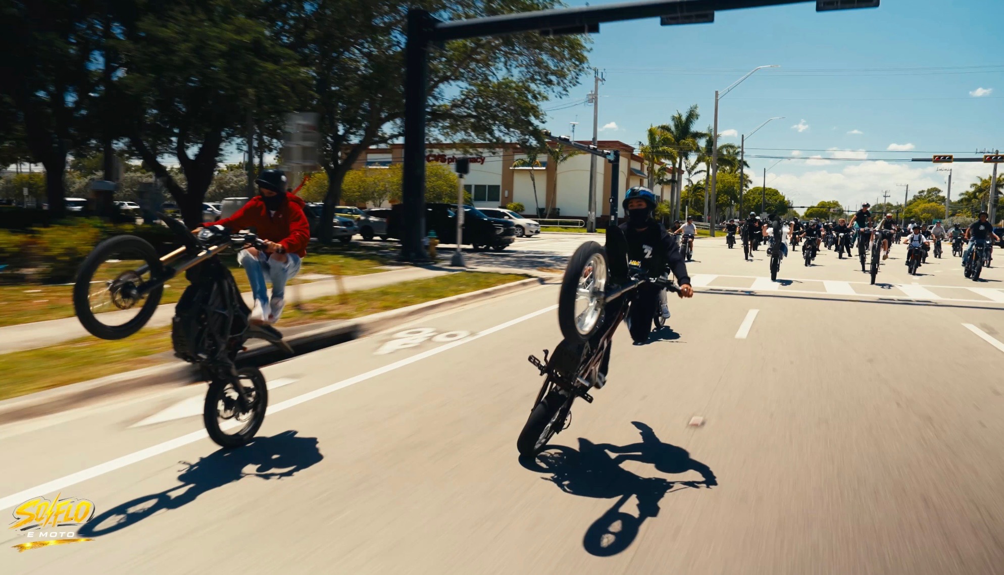 SoFlo E-Moto rideout crew filling the street with bikes and wheelies