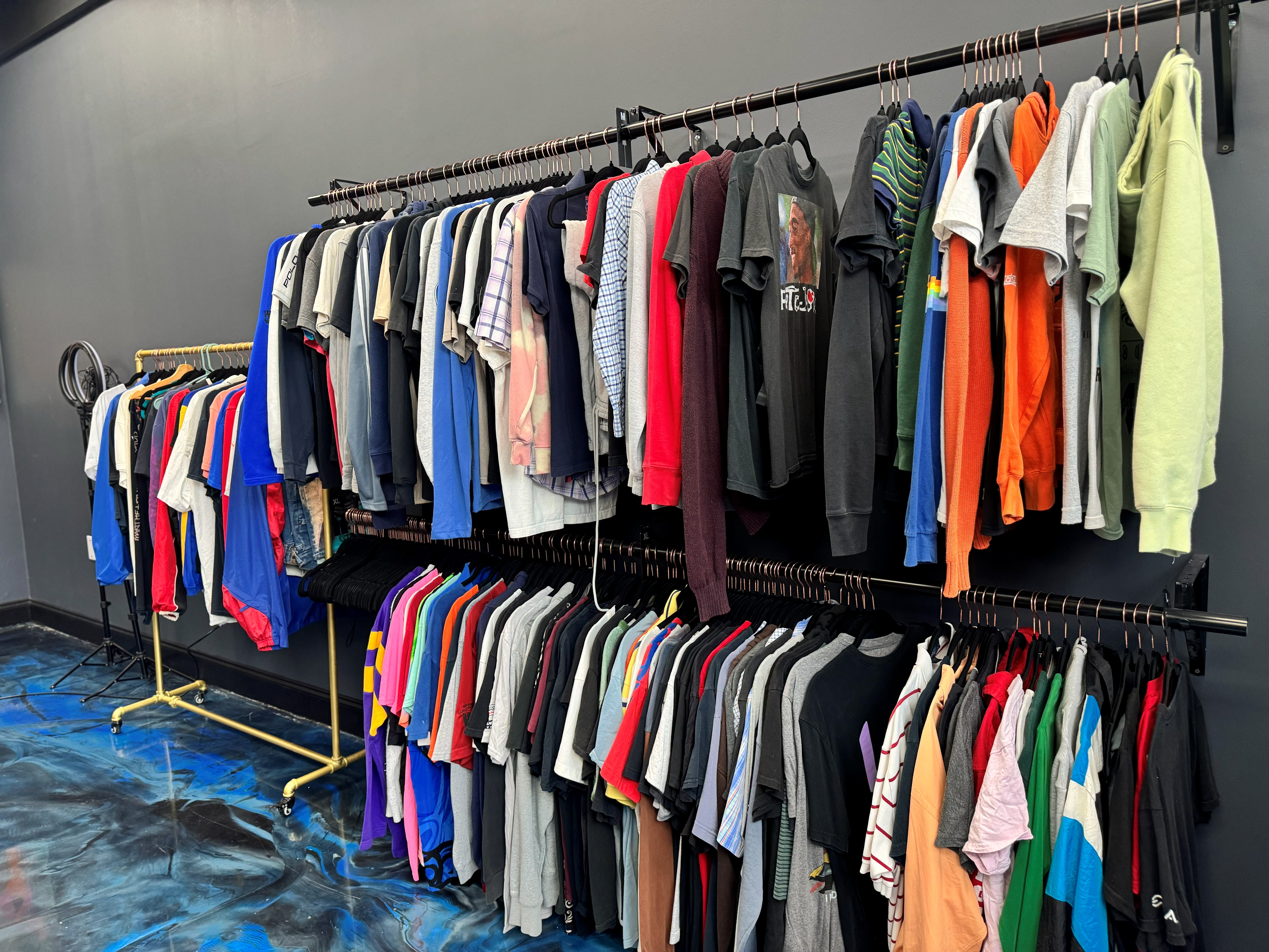 Vintage shirts and gear hanging on racks inside the SoFlo E-Moto shop